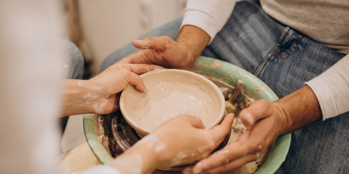 Young couple at a pottery class together